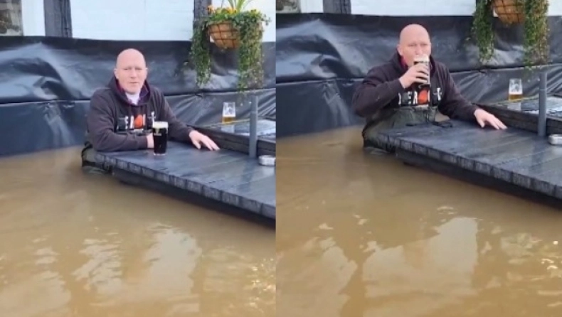 Επικός τύπος απολαμβάνει την μπύρα του έξω από το πλημμυρισμένο του μαγαζί (vid)